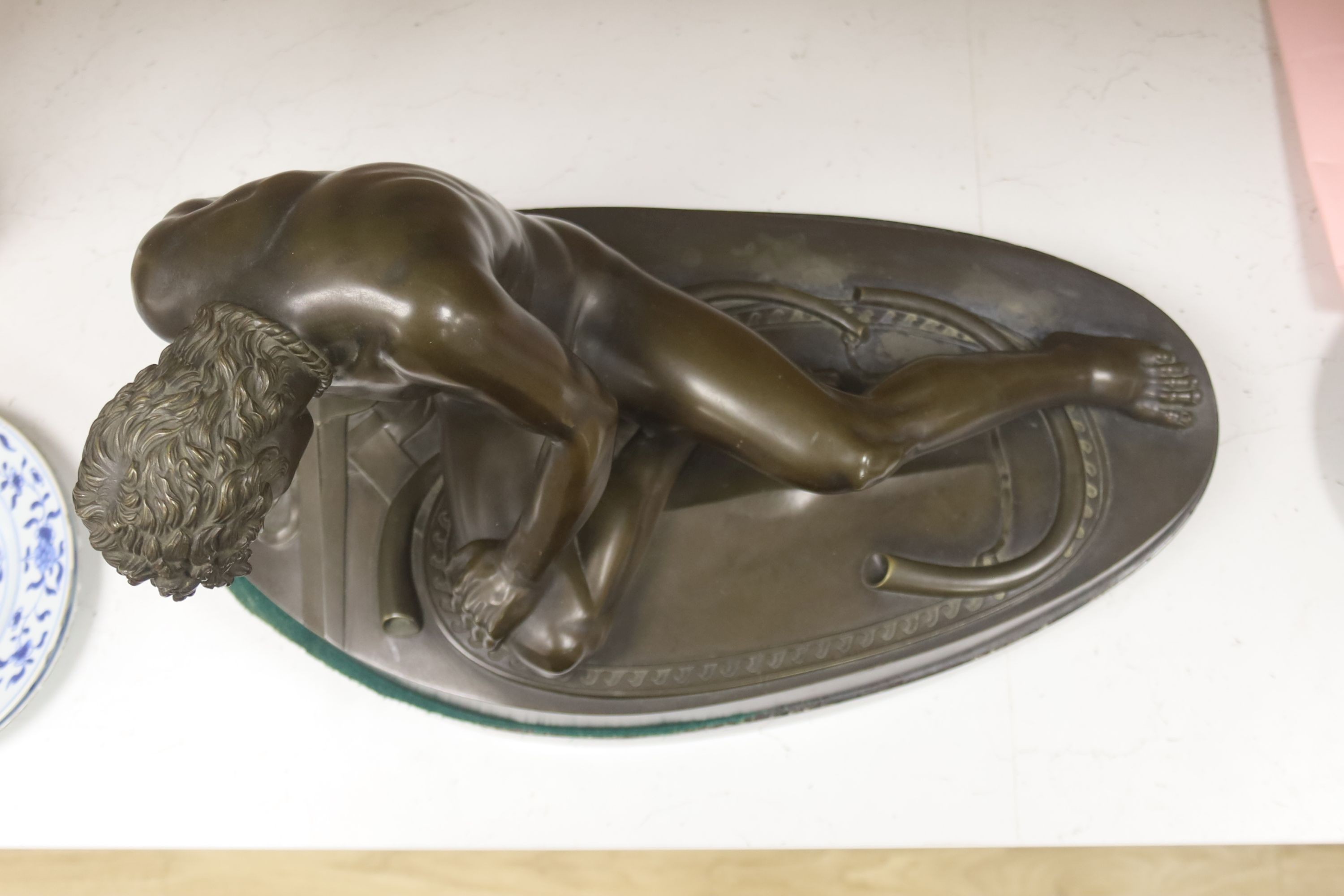 After the Antique, a large bronze figure of 'The Dying Gaul', on a marble plinth, length 55cm